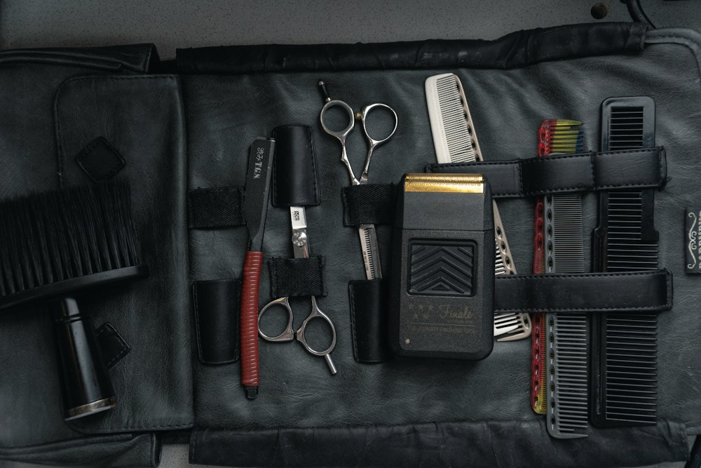 Clippers, scissors and combs laid out in a case